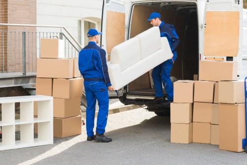 Movers carrying items on a residential street in Camden